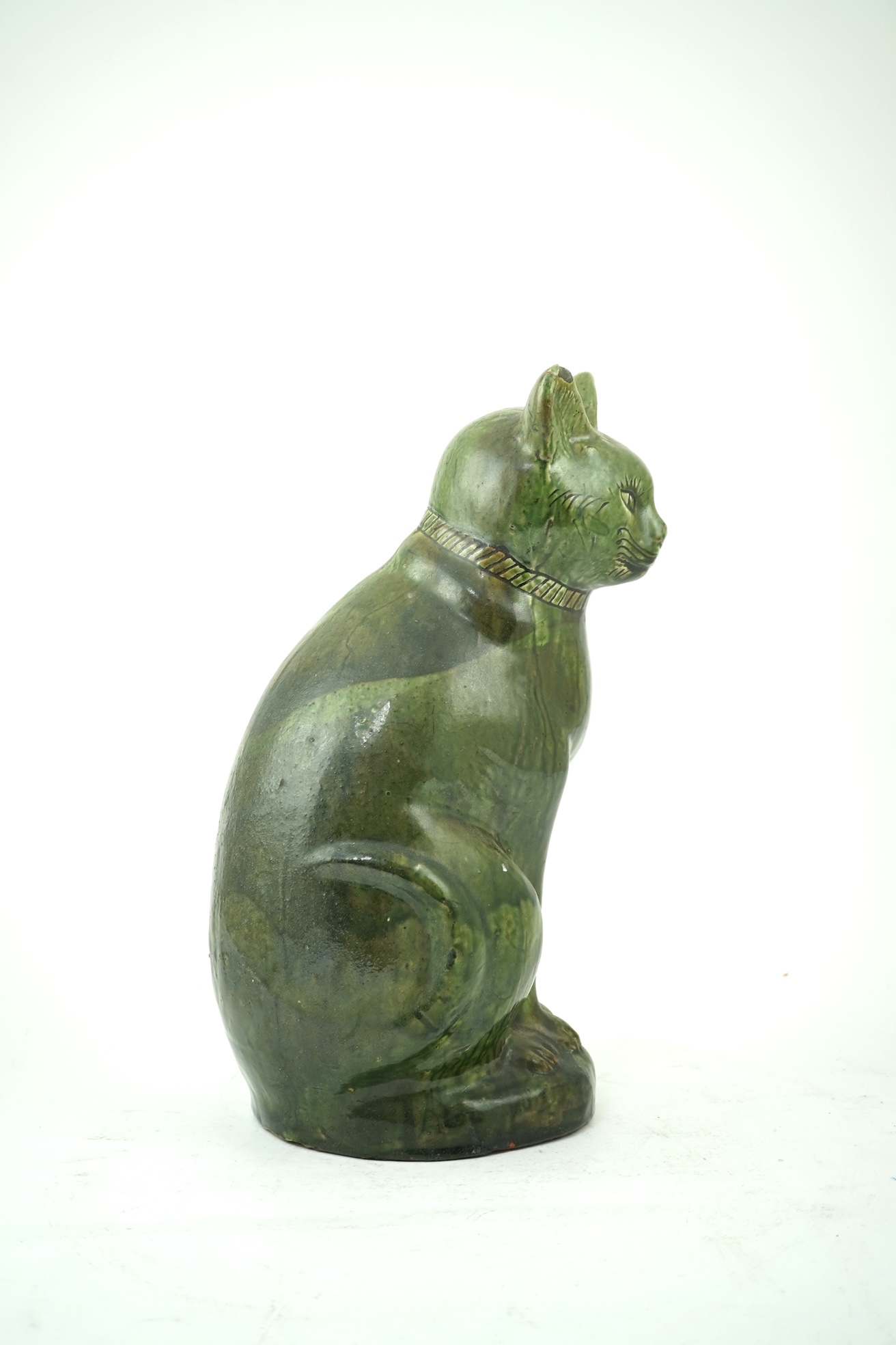 Ewenny Pottery: A large green-glazed figure of a seated cat